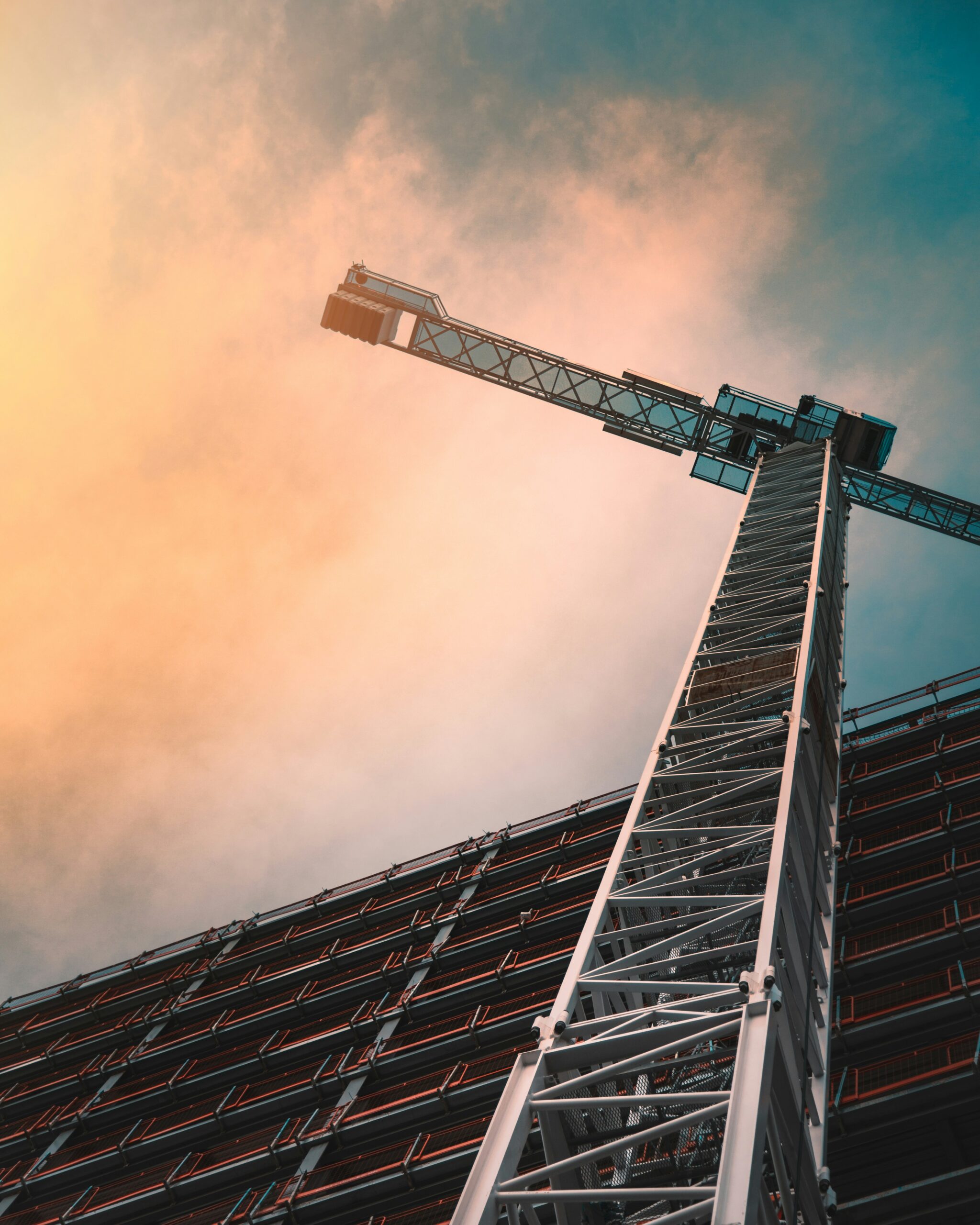 View from below showing a building create next a building under construction.